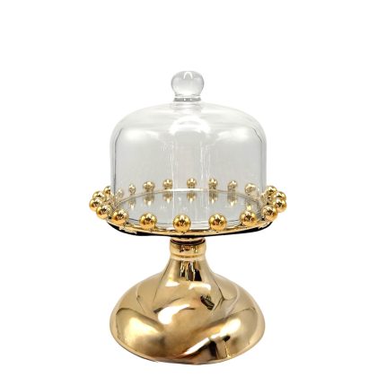 Gold-toned pedestal cake stand with a glass cloche and decorative gold bead rim.