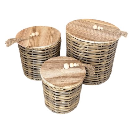 Three woven wicker baskets with matching wooden lids and tassels for storage (varying sizes).