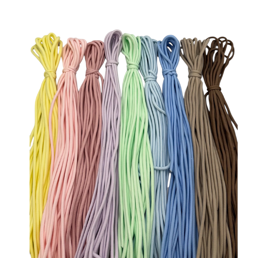 4E1C0880-975D-6CC5-7329-019D0AB1F001_21 | La Vie en Rose Bundles of colorful thin cords tied at the top, arranged in pastel to earthy colors (yellow, pink, lavender, mint, light blue, blue, tan, brown).