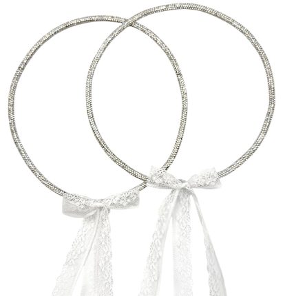 Two silver rhinestone headbands with white lace ribbons, arranged in a bridal display.