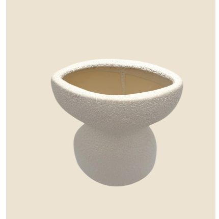 White textured ceramic bowl on a rounded stem, set against a beige background.