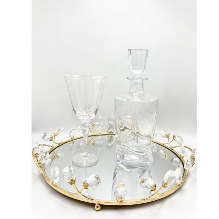 Crystal decanter and a stemmed glass on a mirrored gold-trimmed tray with crystal bead accents.