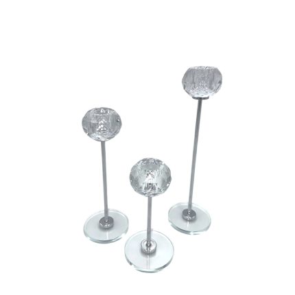 Three decorative crystal glass spheres mounted on slim metal rods with round glass bases at varying heights.