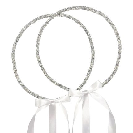 Two silver beaded halo headbands with white satin bow ribbons for a bridal look