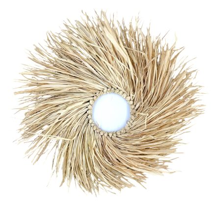 Round decorative straw sunburst with a white center centerpiece, made of dried fibers.