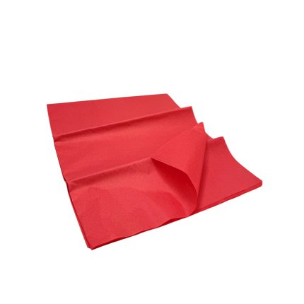 Red paper napkin with creases, partially folded on a white background