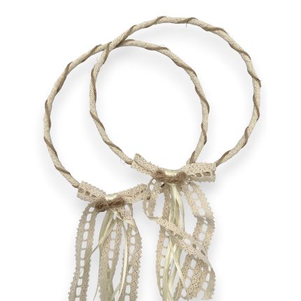 Two braided beige rope circles tied with cream lace ribbons forming a decorative accessory.