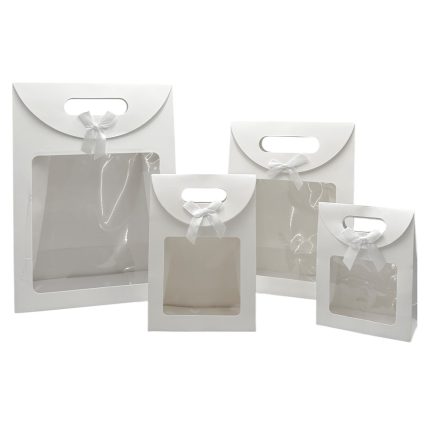 Set of white gift bags with clear plastic windows and white satin bows.