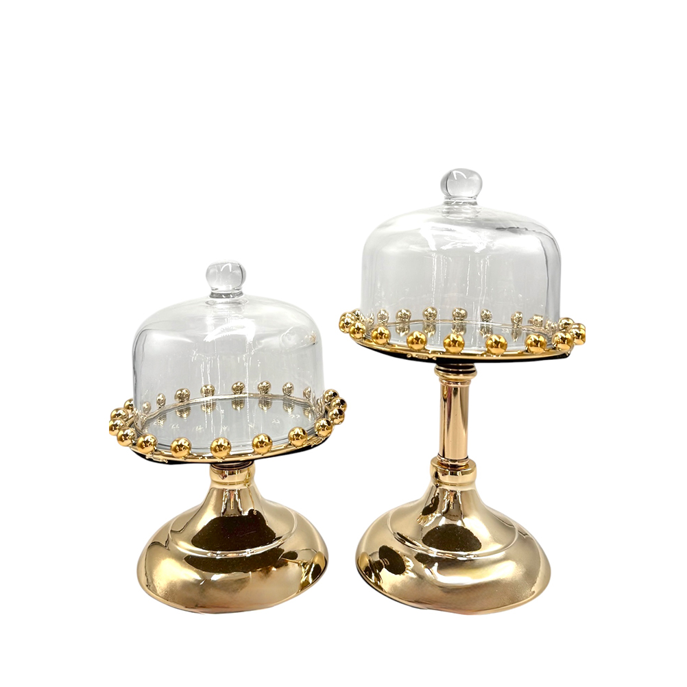 E5E0FC55-4BA5-D7C3-5458-019D4DBB39D5_21 | La Vie en Rose Two gold pedestal cake stands with glass domes and beaded rims, set side by side.