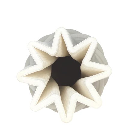 Top-down view of a white multi-pointed star origami napkin folded inside a round white holder.